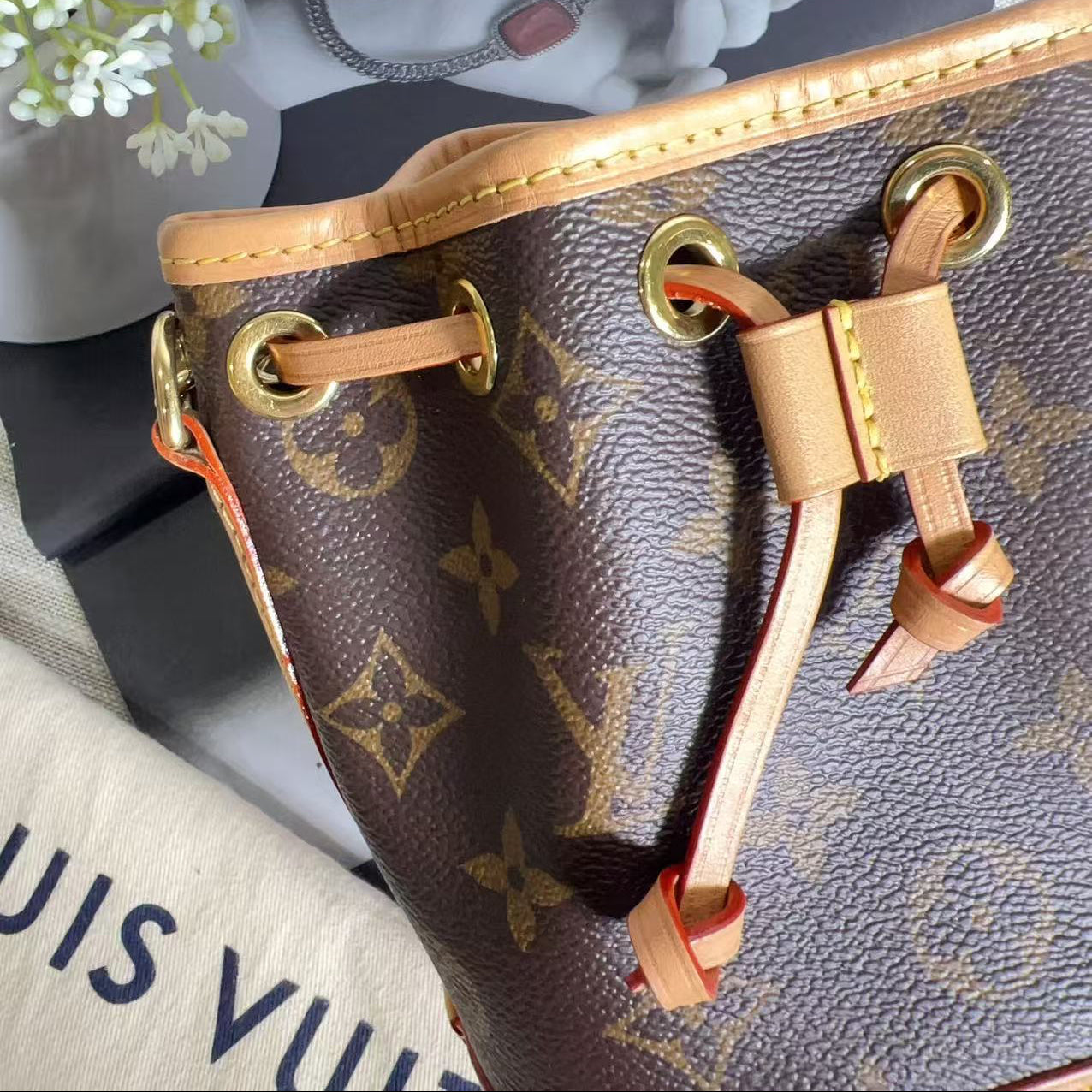 Close-up of a Louis Vuitton handbag strap with monogram pattern