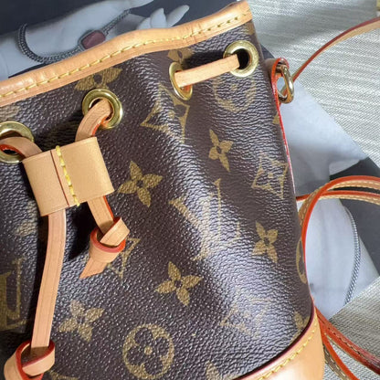 Louis Vuitton handbag with monogram pattern on a textured surface