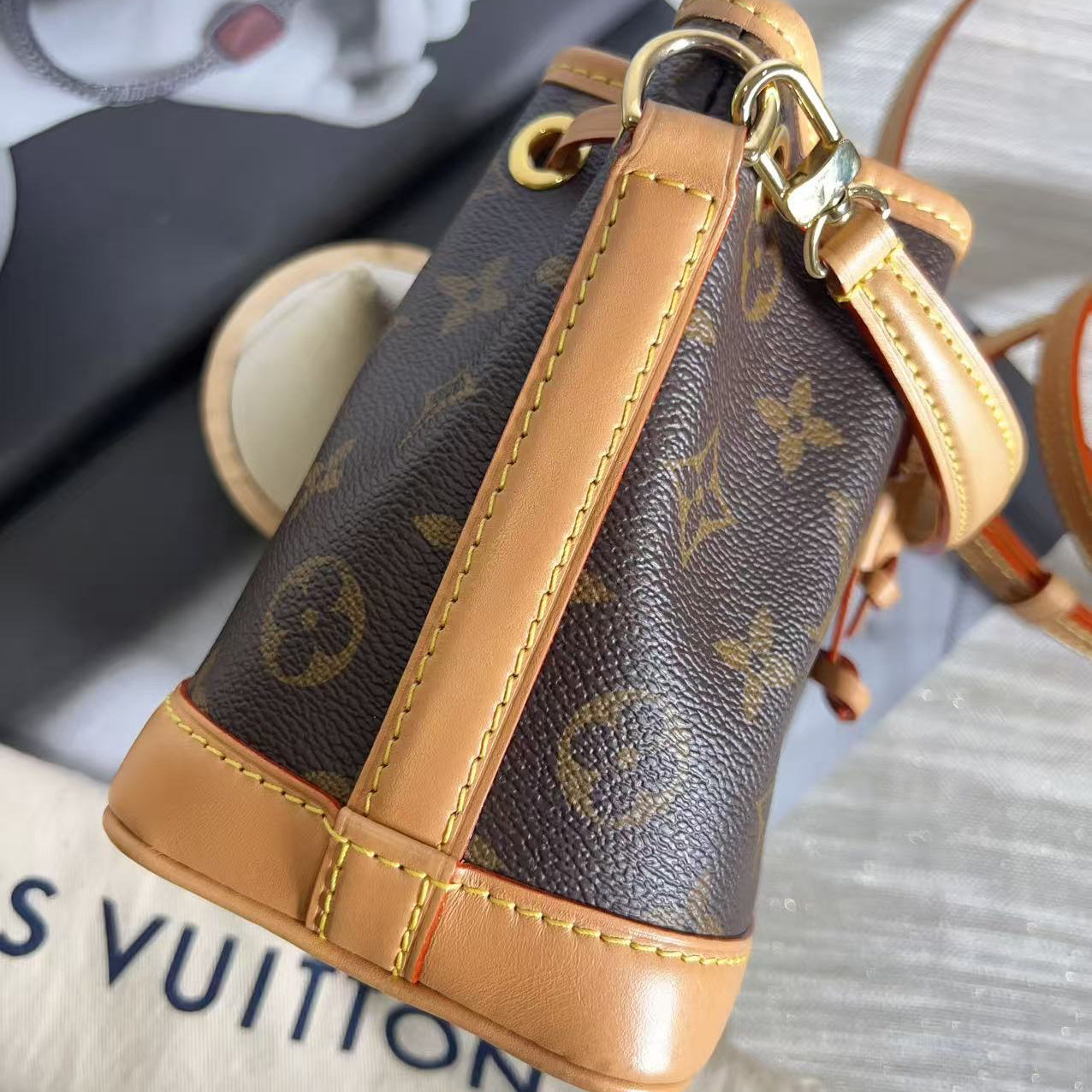 Louis Vuitton keychain with monogram pattern on a textured surface