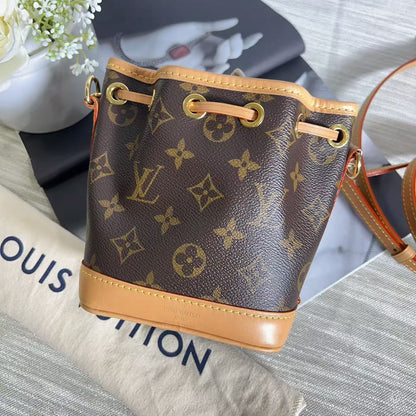 Louis Vuitton handbag with monogram pattern on a surface with 'Louis Vuitton' branding.
