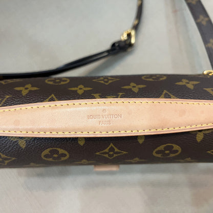 Louis Vuitton monogram canvas shoulder bag in dark brown with tan leather trim and strap, featuring the embossed Louis Vuitton Paris logo on the center leather tab.