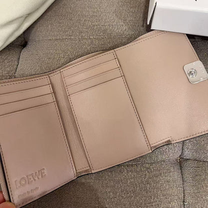 Beige wallet with Loewe branding on a textured surface
