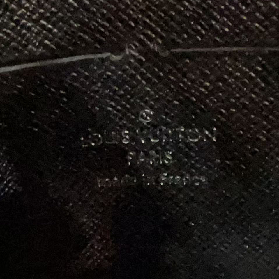 Close-up of a textured surface with 'Louis Vuitton' branding.