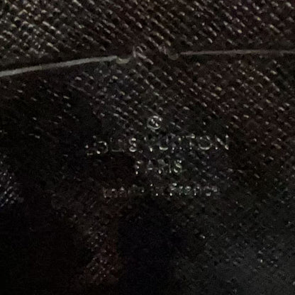 Close-up of a textured surface with 'Louis Vuitton' branding.