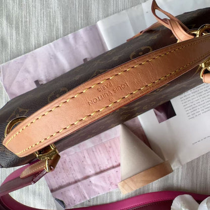 Close-up of a Louis Vuitton handbag strap on a textured surface