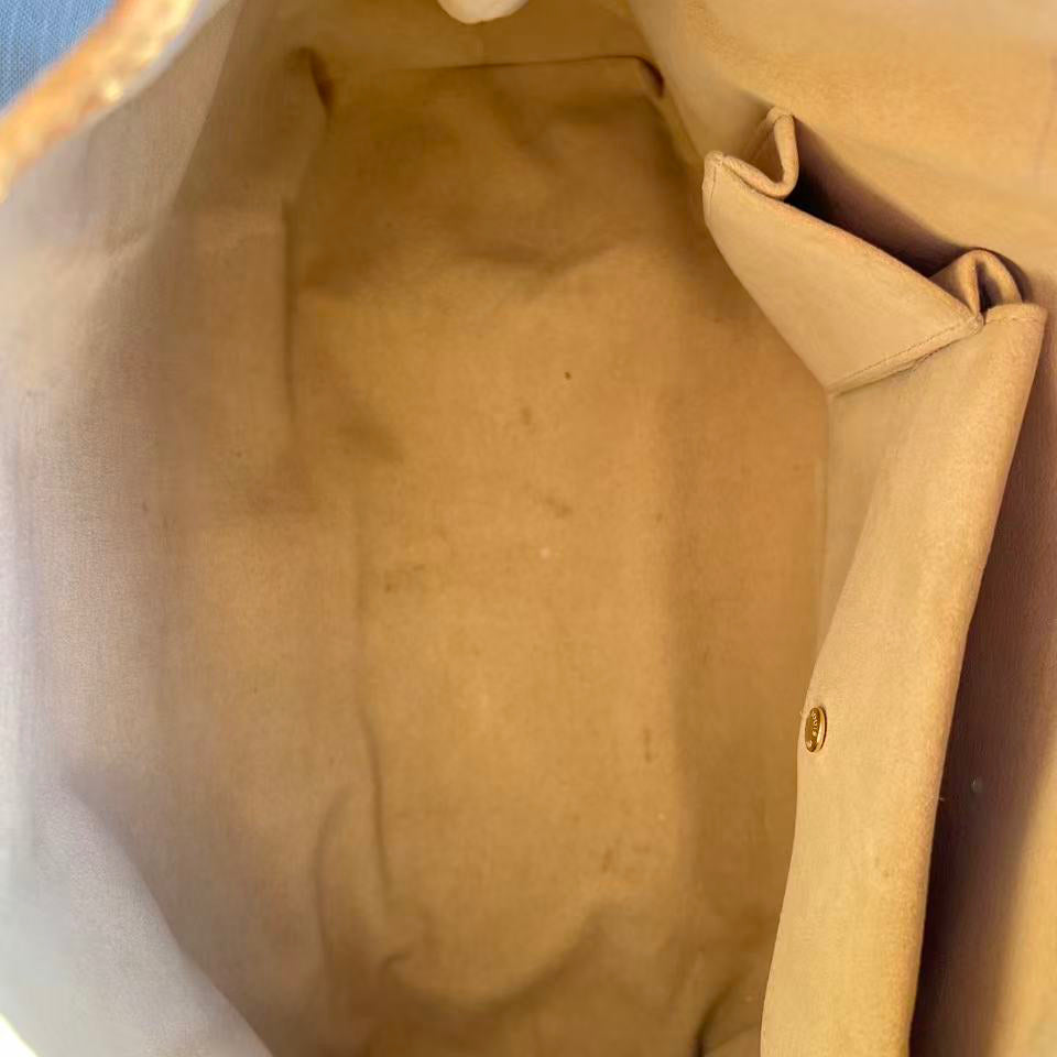 Close-up of a brown leather bag with visible stitching and texture.