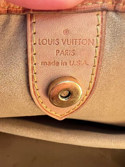 Louis Vuitton wallet with brand name and 'made in U.S.A.' text on leather tag.