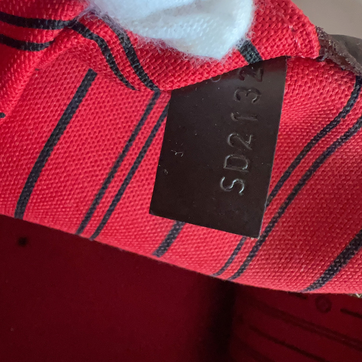 Red plaid fabric with a black label displaying 'SD213' on a white background