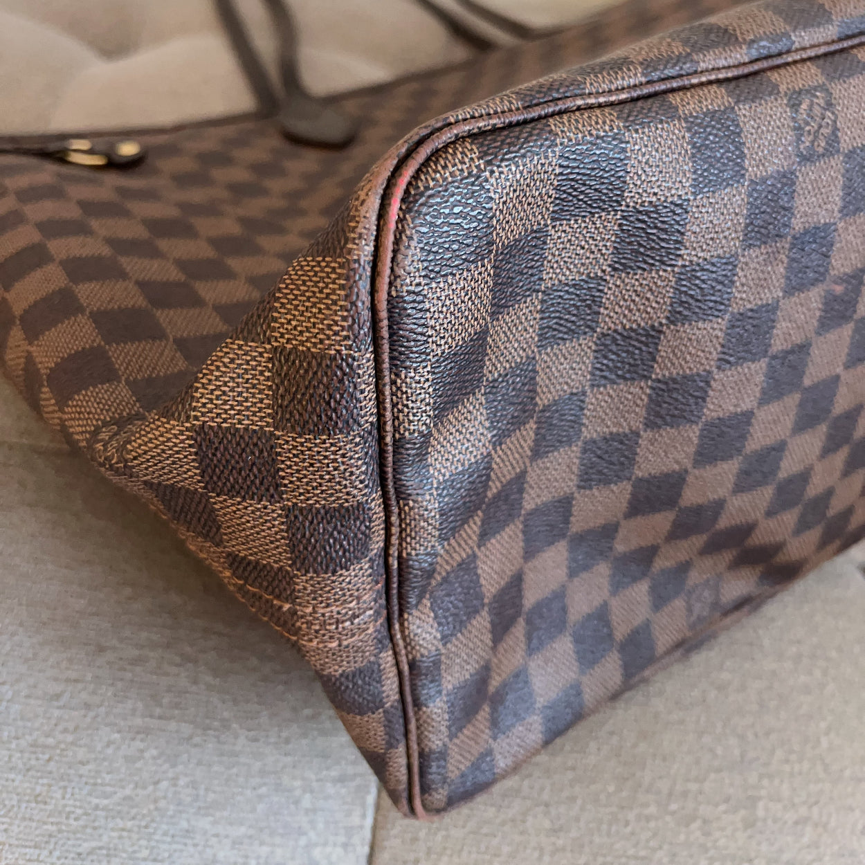 Designer handbag with checkered pattern on a light background
