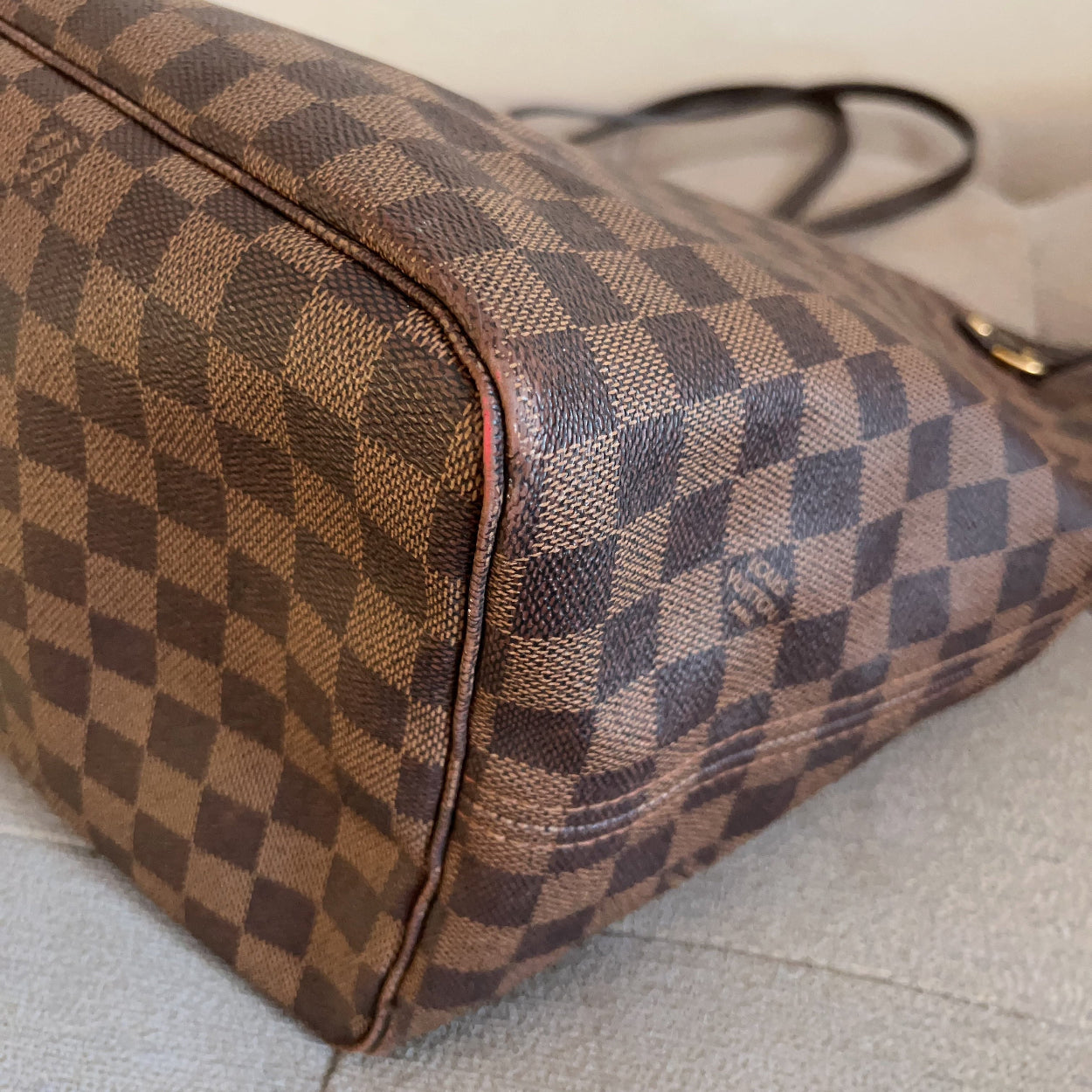 Designer handbag with checkered pattern on a light background