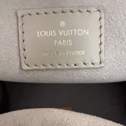 Louis Vuitton label on a textured surface