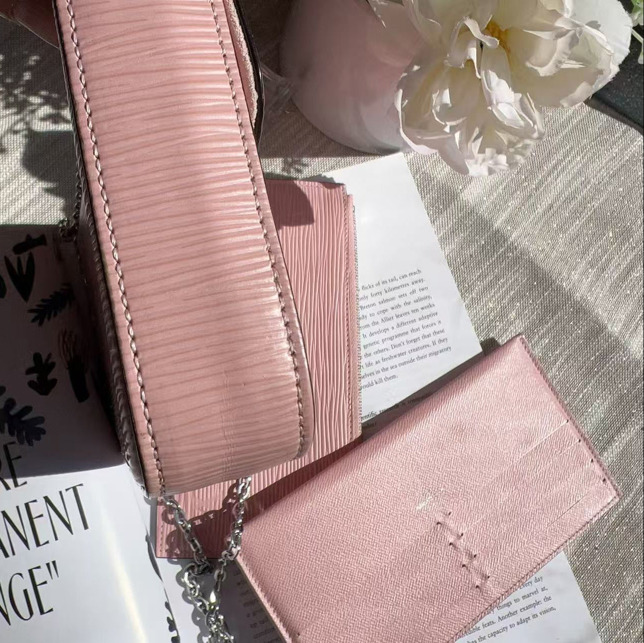 Pink textured wallet on an open book 