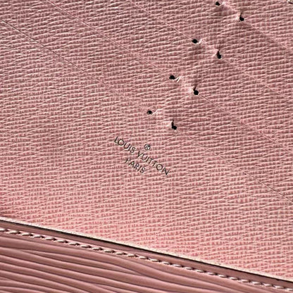 Close-up of a pink textured surface with a brand logo.