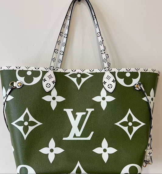 Green handbag with white monogram pattern on a light gray background
