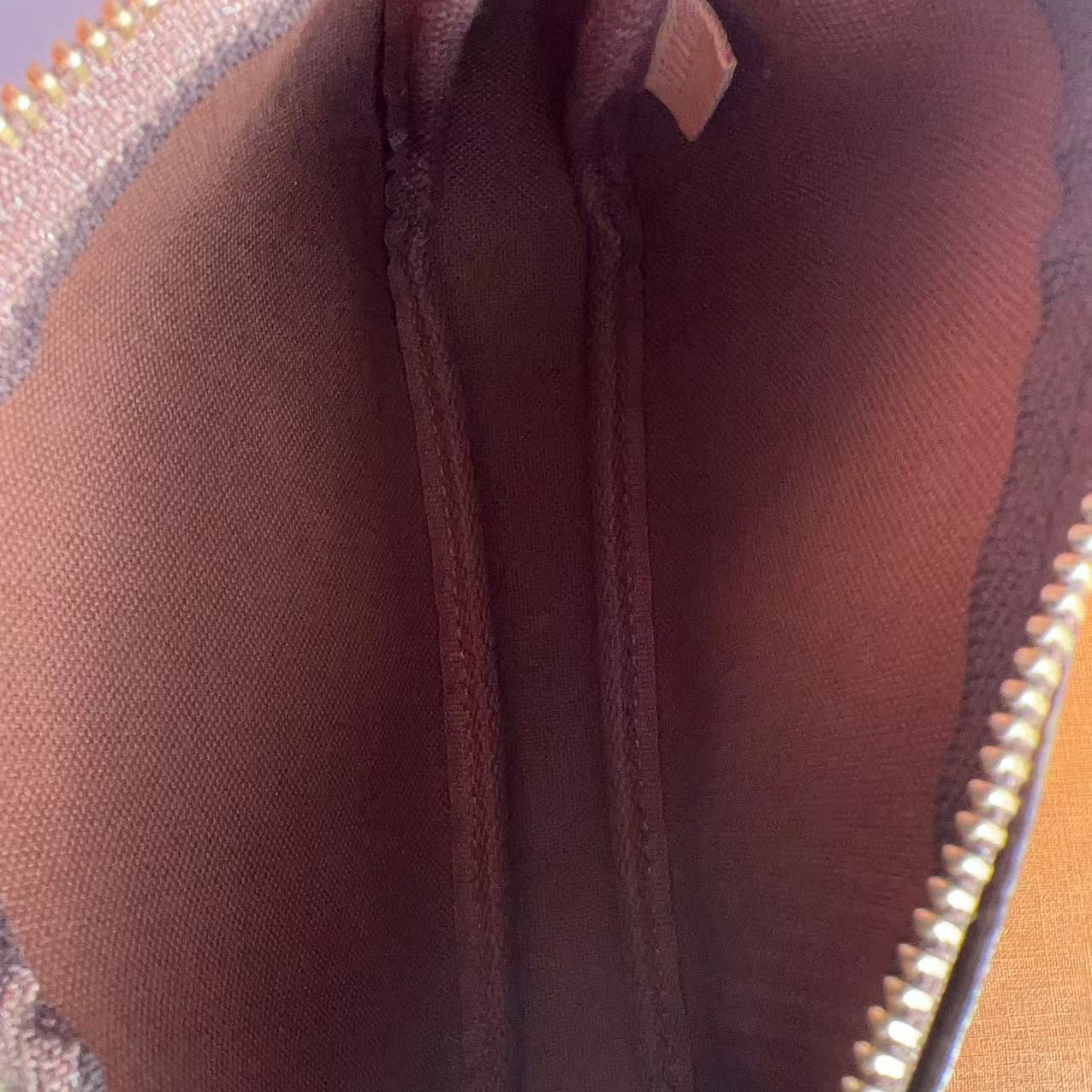 Close-up of a brown textured pouch with a zipper.