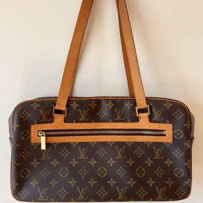 Designer handbag with monogram pattern on a plain background