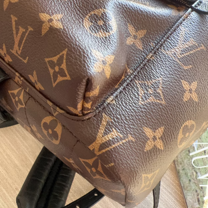 Brown leather bag with monogram pattern on a chair