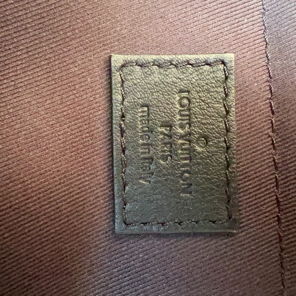 Textile label on a brown fabric surface