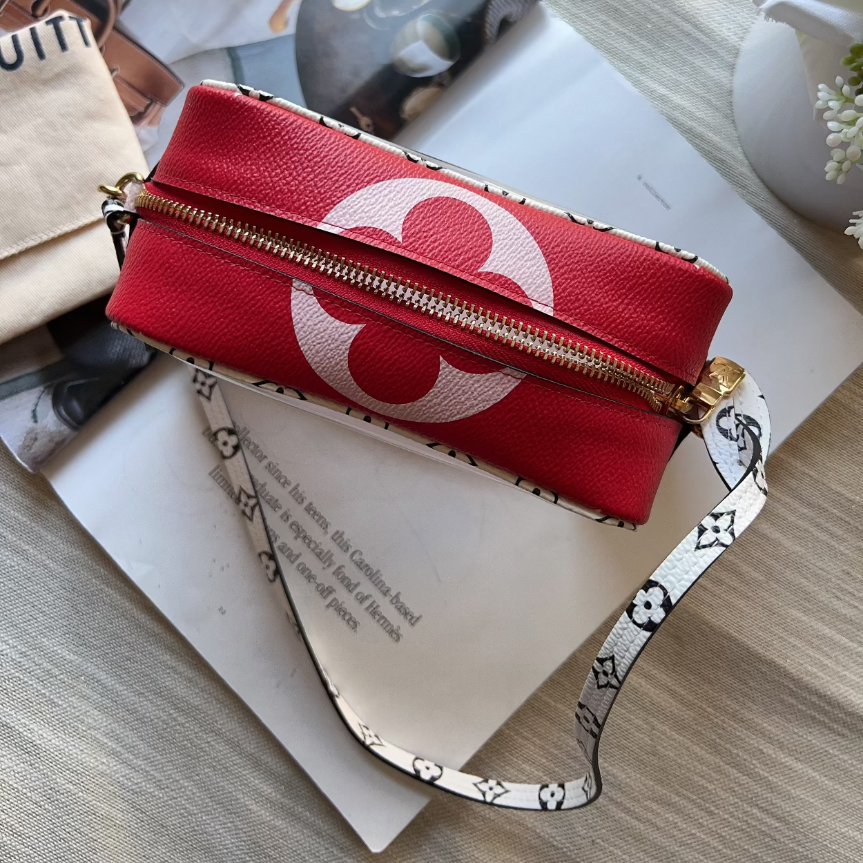 Red pouch with a white logo on a magazine