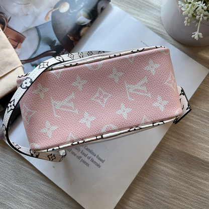Pink handbag with monogram pattern on a magazine