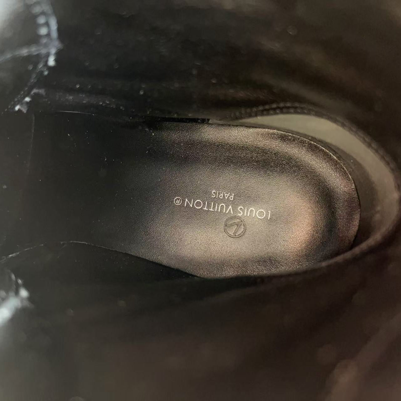 Close-up of a Louis Vuitton shoe sole with brand logo.