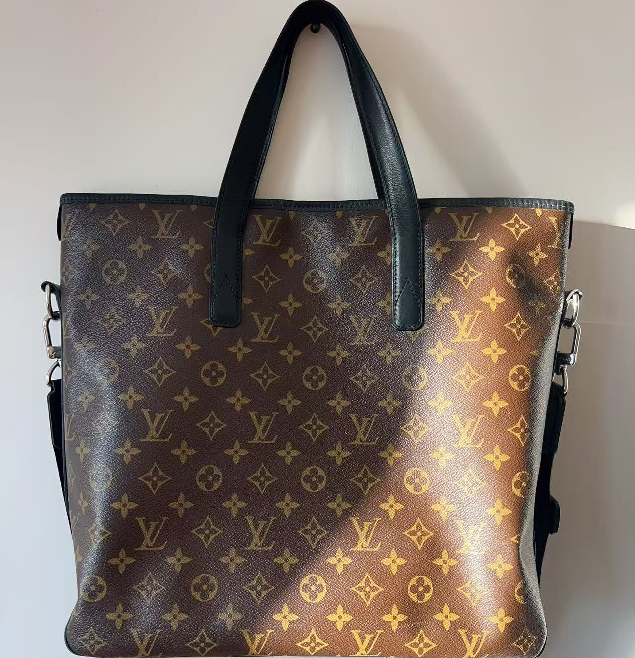 Designer handbag with monogram pattern on a plain background