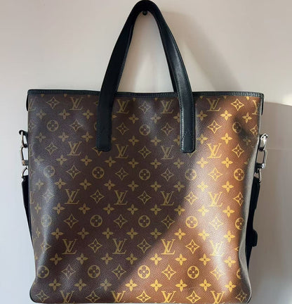 Designer handbag with monogram pattern on a plain background