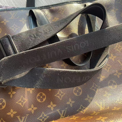 Black leather strap on a Louis Vuitton monogram handbag