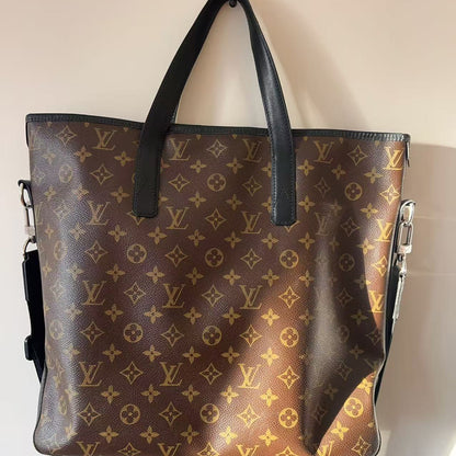Designer handbag with monogram pattern on a neutral background
