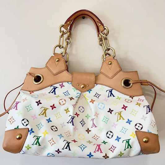 Designer handbag with multicolor monogram pattern on a light background