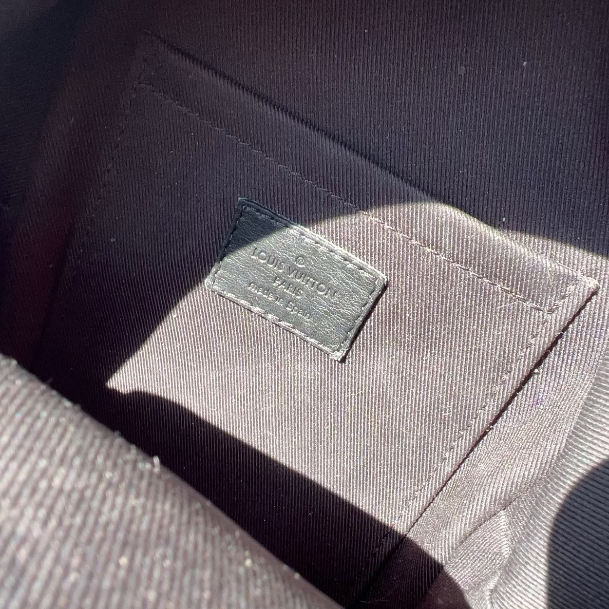 Close-up of a label on a dark fabric surface