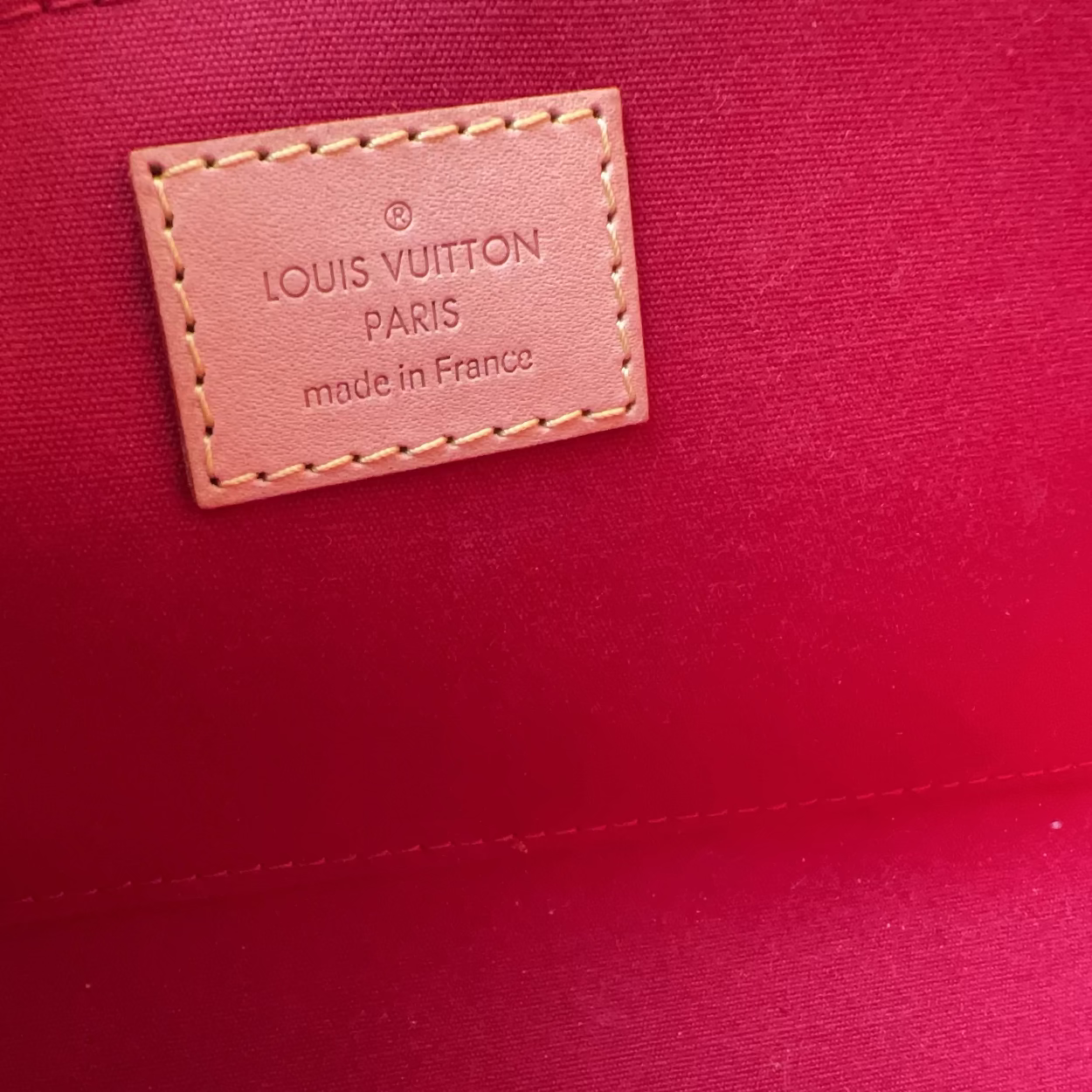 Louis Vuitton label on a red fabric background