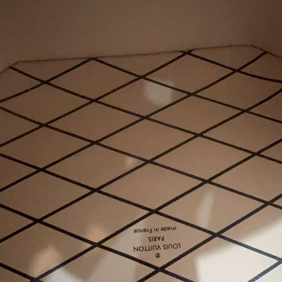 Louis Vuitton patterned surface with brand name and logo.