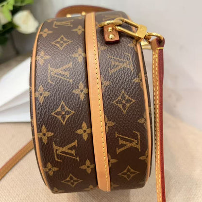 Louis Vuitton handbag with monogram pattern on a neutral background