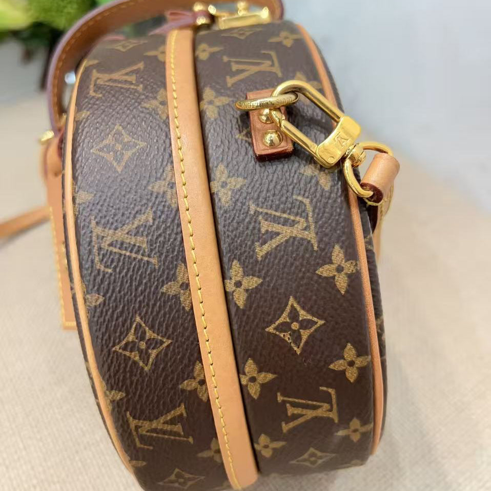 Louis Vuitton handbag with monogram pattern on a light background