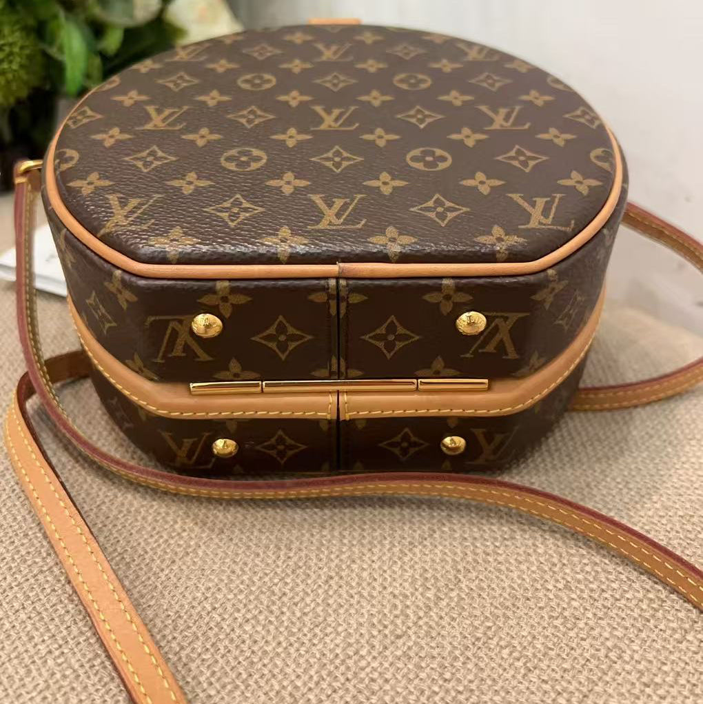 Designer handbag with monogram pattern on a textured surface