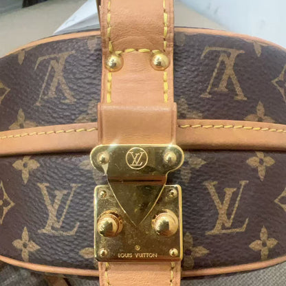 Close-up of a Louis Vuitton handbag with monogram pattern and gold hardware.