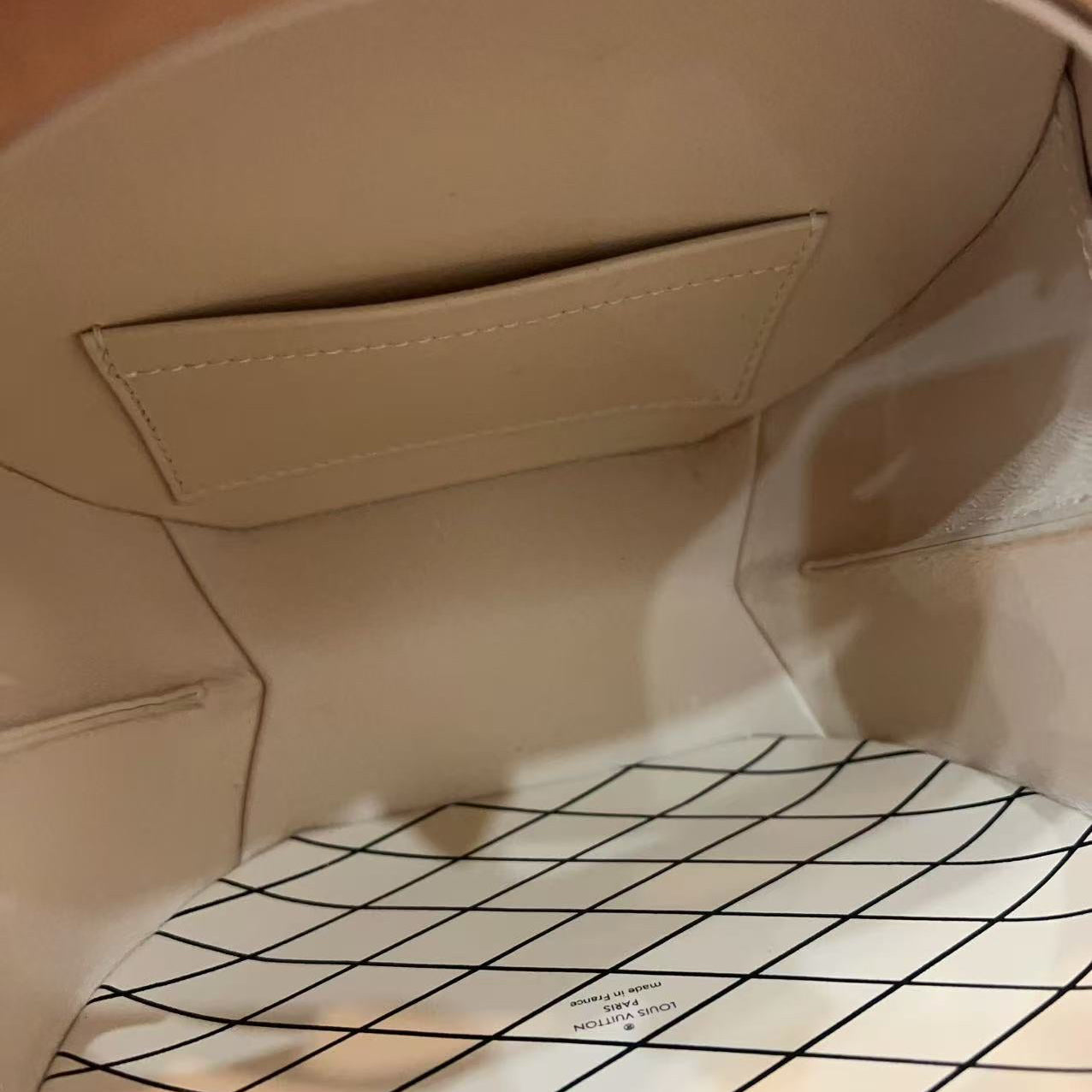 Close-up of a beige fabric interior with a grid pattern