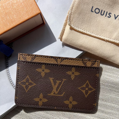 Louis Vuitton wallet with monogram pattern on a textured surface