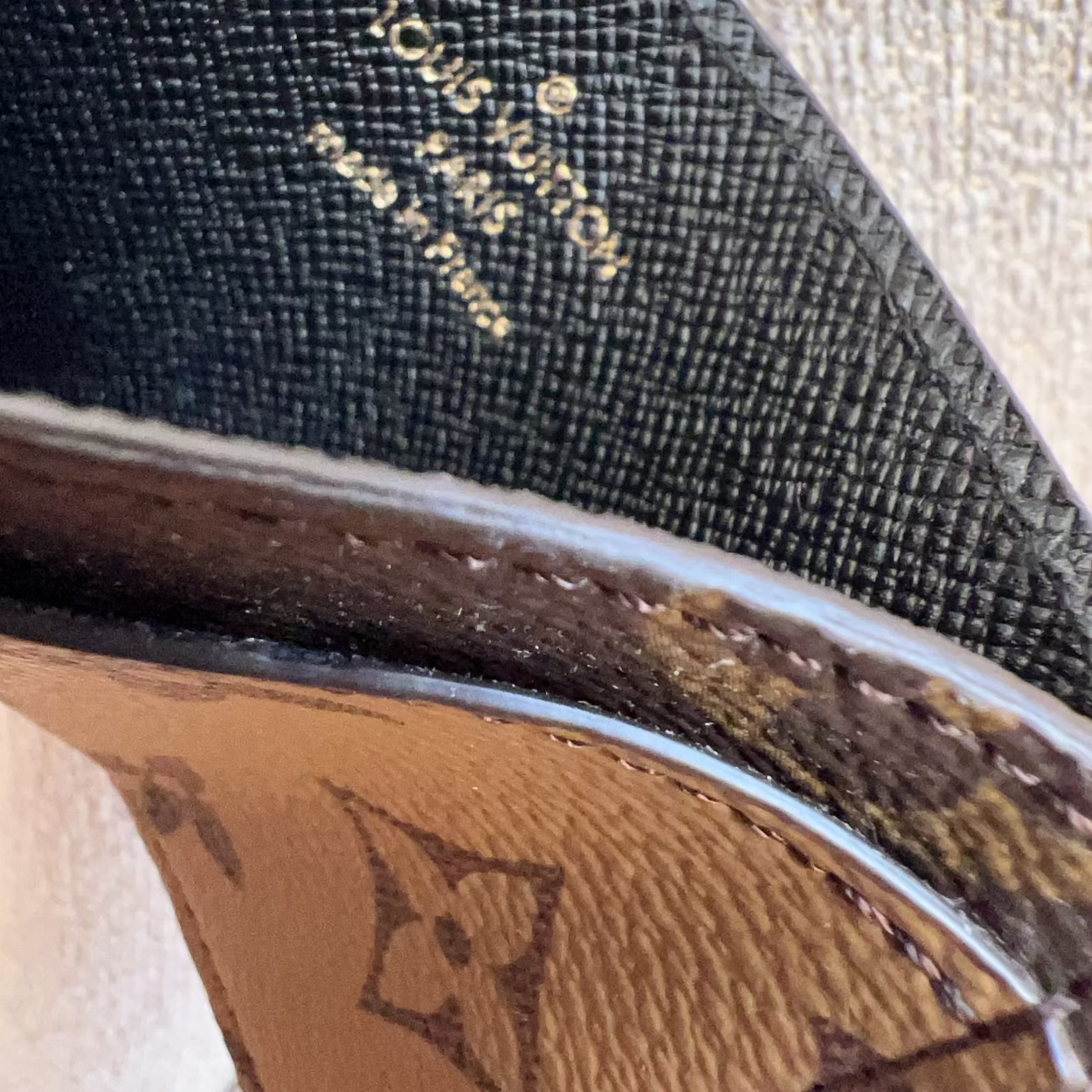 Close-up of a Louis Vuitton shoe with branding details.