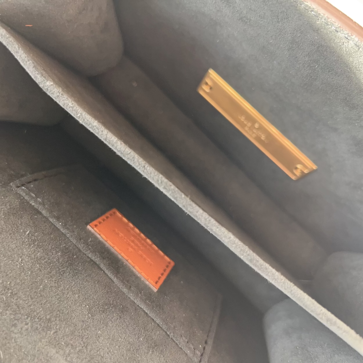 Close-up of a textured surface with a gold and orange label.