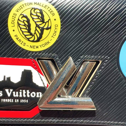 Louis Vuitton handbag with brand logo and packaging in the background