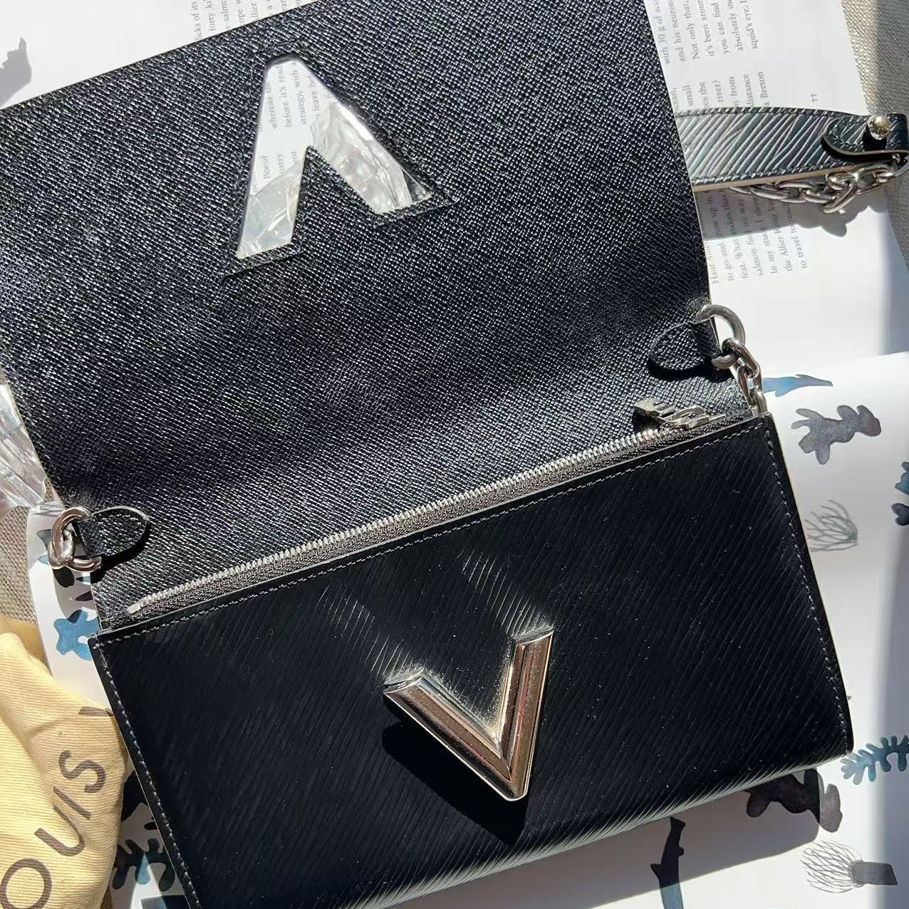 Black handbag with a silver logo 