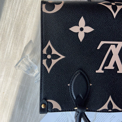 Black pouch with beige monogram pattern on a light gray surface