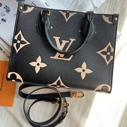 Black handbag with beige monogram pattern on a light surface