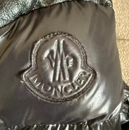 Close-up of a Moncler logo on a metallic surface