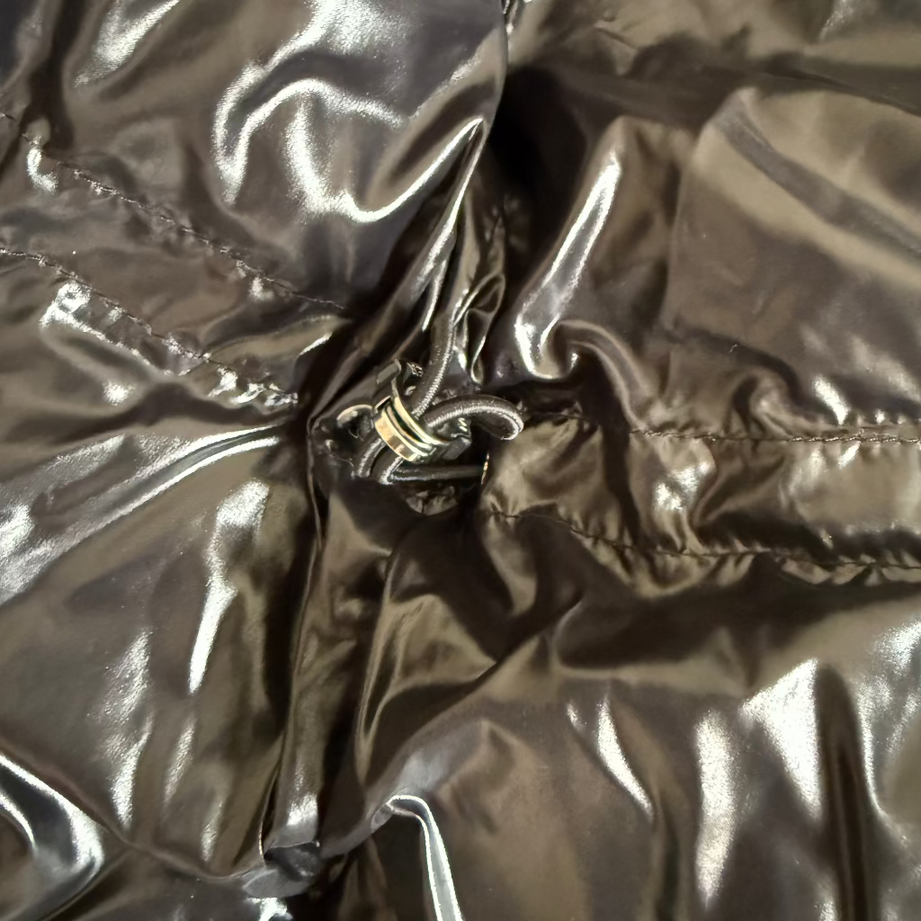 Close-up of a shiny metallic fabric with a zipper