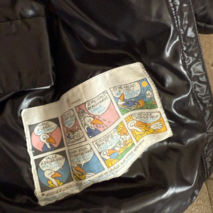 Comic-style wallet with colorful illustrations on a black leather surface