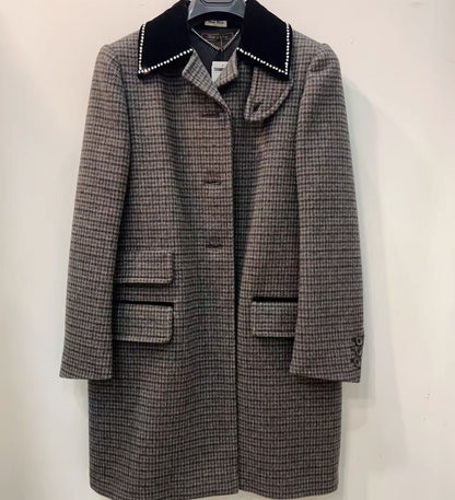 Houndstooth pattern coat with black collar on a white background