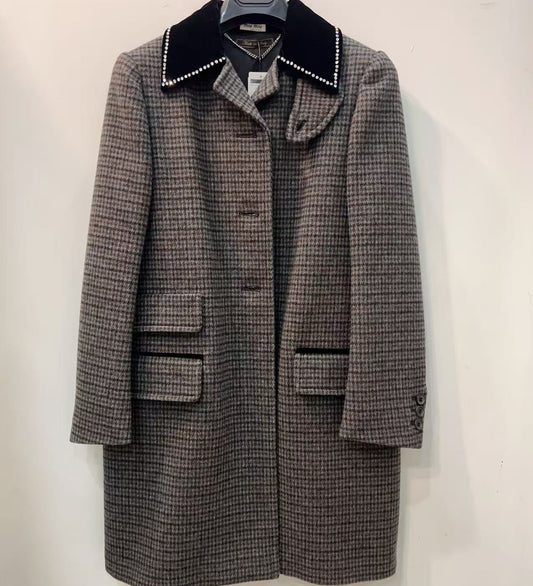 Houndstooth pattern coat with black collar on a white background